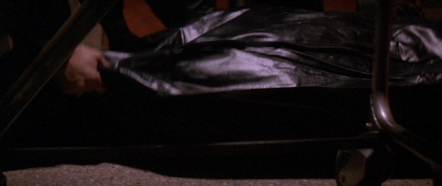 Frame from Die Hard 2 — standing, room, hand