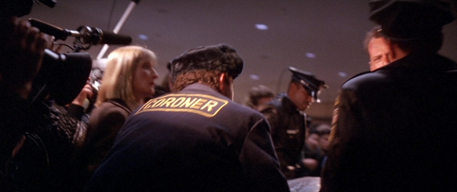 Wide shot frame from Die Hard 2 — standing, dialogue, uniform