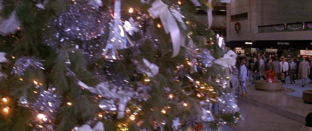 Wide shot frame from Die Hard 2 — walking, person, building