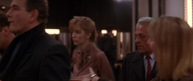 Wide shot frame from Die Hard 2 — standing, room, dialogue