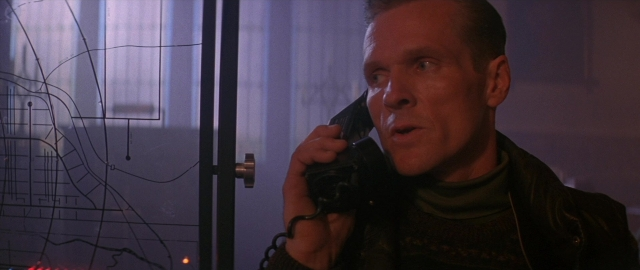 Medium shot frame from Die Hard 2 — standing, room, dialogue