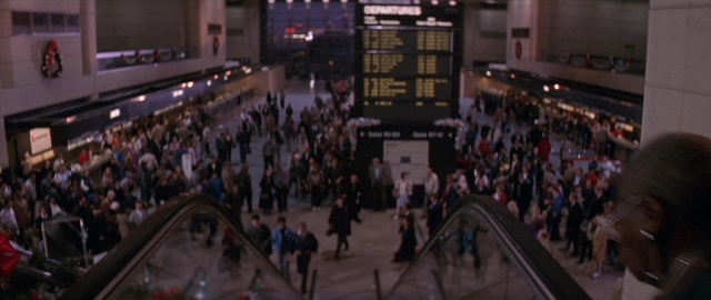Wide shot frame from Die Hard 2 — walking, train, person
