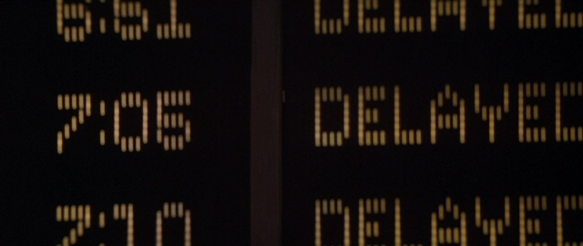 Wide shot frame from Die Hard 2 — train, digital clock