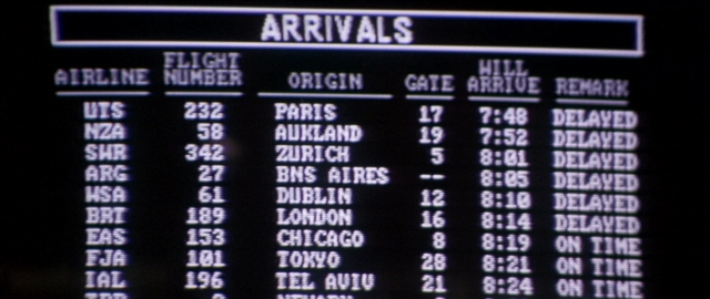 Wide shot frame from Die Hard 2 — airplane, scoreboard