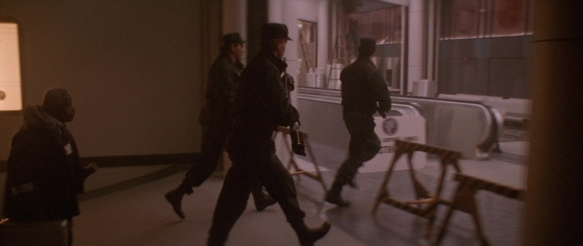 Wide shot frame from Die Hard 2 — walking, person, footwear