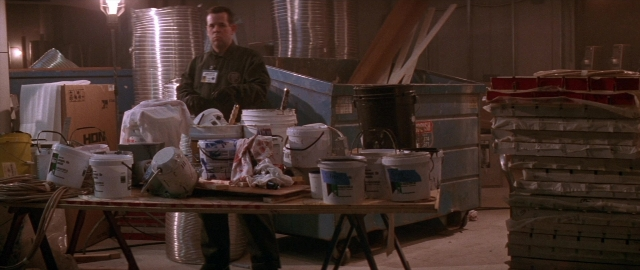 Wide shot frame from Die Hard 2 — standing, table, face