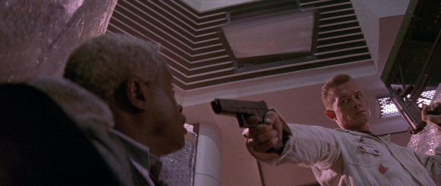 Wide shot frame from Die Hard 2 — standing, room, dialogue