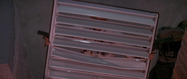 Wide shot frame from Die Hard 2 — standing, room, furniture