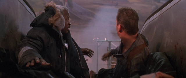 Frame from Die Hard 2 — sitting, car, hand