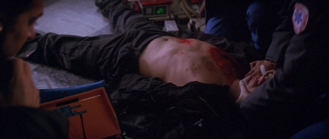 Wide shot frame from Die Hard 2 — hand, person, human face