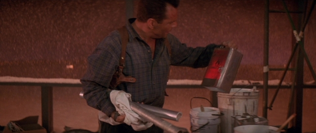 Wide shot frame from Die Hard 2 — standing, room, shirt