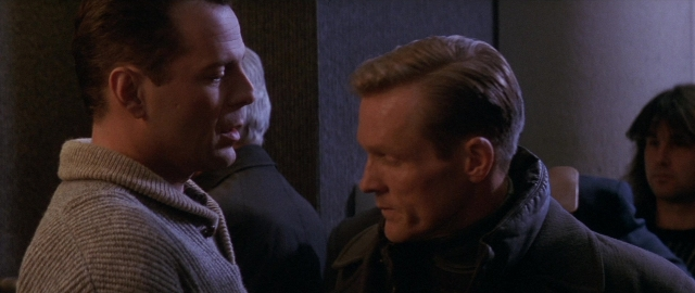 Wide shot frame from Die Hard 2 — sitting, room, dialogue
