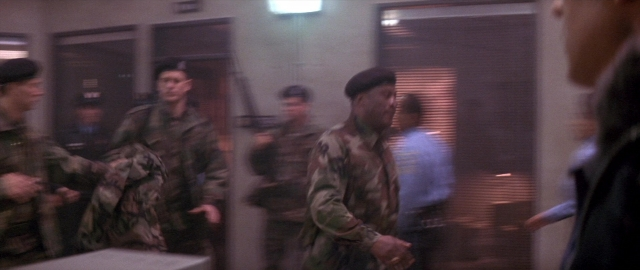 Wide shot frame from Die Hard 2 — walking, door, person