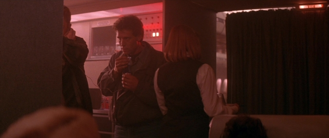 Wide shot frame from Die Hard 2 — standing, room, dialogue