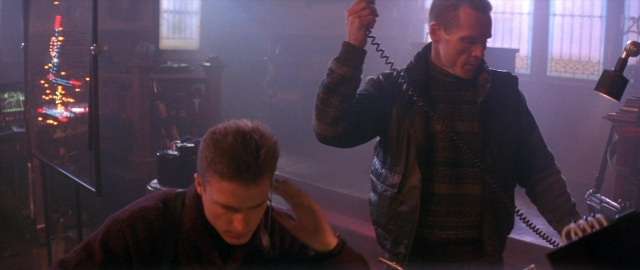 Frame from Die Hard 2 — sitting, standing, room