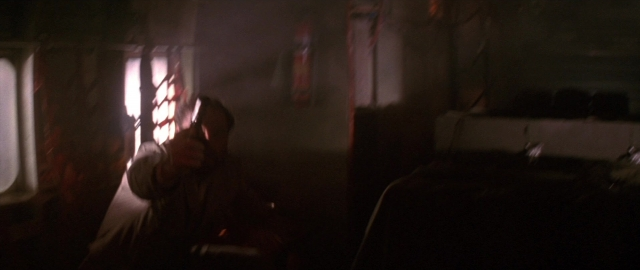 Wide shot frame from Die Hard 2 — sitting, room, table