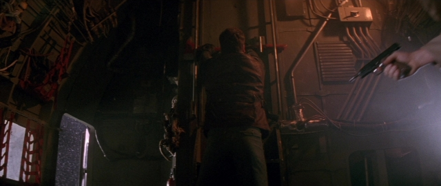 Wide shot frame from Die Hard 2 — standing, room, hand