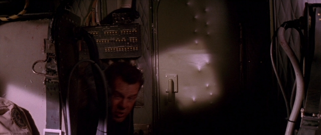 Wide shot frame from Die Hard 2 — standing, room, face
