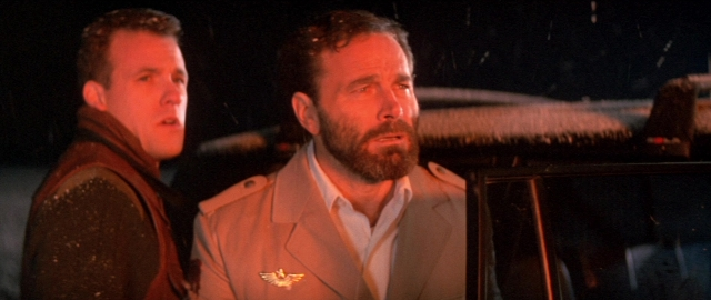Medium shot frame from Die Hard 2 — standing, dialogue, street