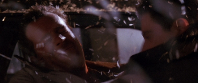 Wide shot frame from Die Hard 2 — standing, room, hand