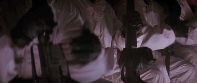 Wide shot frame from Die Hard 2 — sitting, room, person