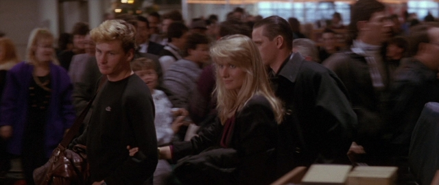 Wide shot frame from Die Hard 2 — standing, room, dialogue