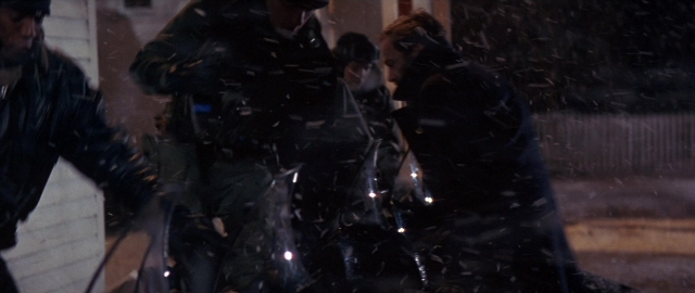 Wide shot frame from Die Hard 2 — standing, street, night