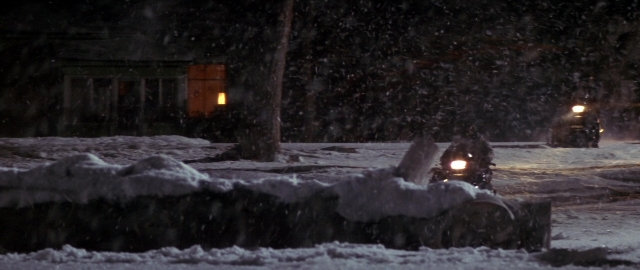 Frame from Die Hard 2 — sitting, street, hat