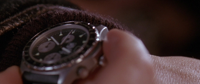 Wide shot frame from Die Hard 2 — watch, hand, clock