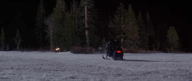 Wide shot frame from Die Hard 2 — street, hat, night