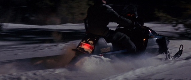 Wide shot frame from Die Hard 2 — street, hat, night