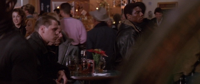 Wide shot frame from Die Hard 2 — sitting, standing, walking