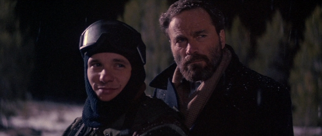Medium shot frame from Die Hard 2 — standing, hat, coat