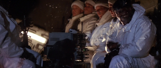 Wide shot frame from Die Hard 2 — sitting, room, dialogue
