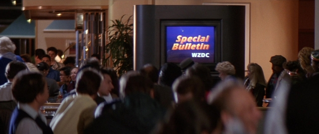 Wide shot frame from Die Hard 2 — room, person, human face
