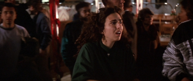 Wide shot frame from Die Hard 2 — sitting, room, table