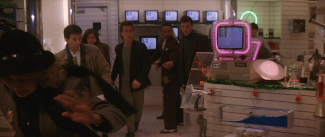 Wide shot frame from Die Hard 2 — room, hand, person