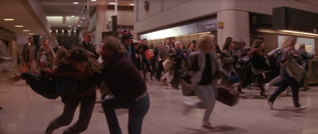 Wide shot frame from Die Hard 2 — walking, person, human face