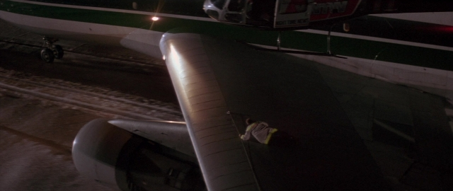 Wide shot frame from Die Hard 2 — standing, street, night