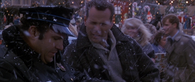 Wide shot frame from Die Hard 2 — sitting, walking, table