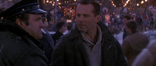 Wide shot frame from Die Hard 2 — standing, dialogue, street
