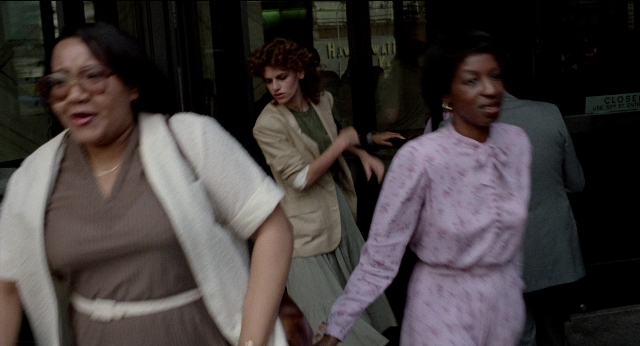 Wide shot frame from The King of Comedy — walking, street, dress