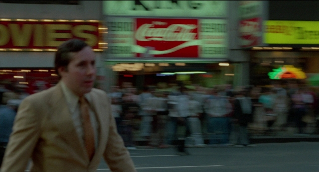 Wide shot frame from The King of Comedy — walking, street, suit
