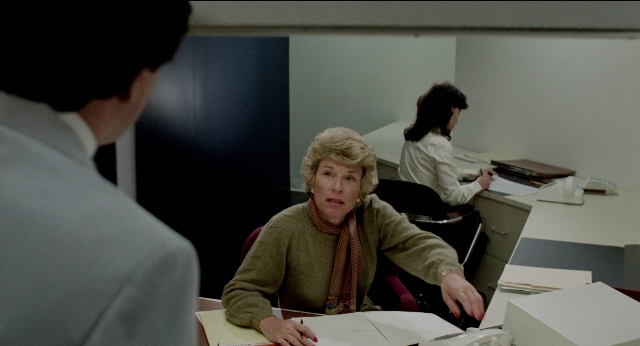 Wide shot frame from The King of Comedy — sitting, phone, suit