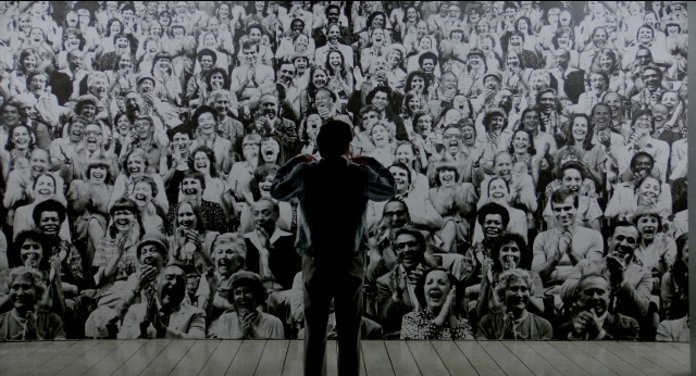 Wide shot frame from The King of Comedy — standing, person, human face