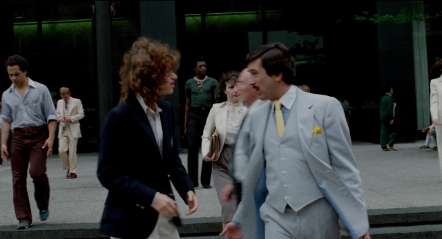 Wide shot frame from The King of Comedy — walking, dialogue, street