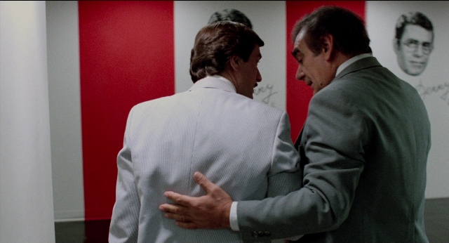 Wide shot frame from The King of Comedy — standing, room, dialogue