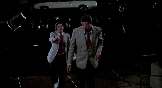 Wide shot frame from The King of Comedy — walking, car, hand