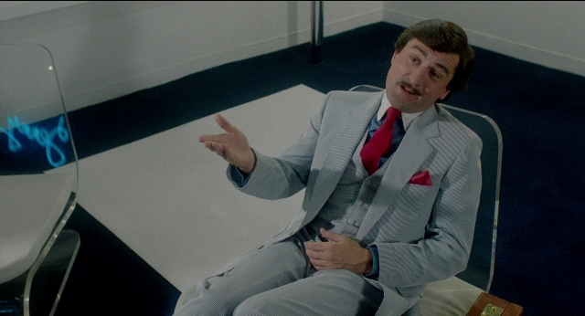 Frame from The King of Comedy — sitting, room, table