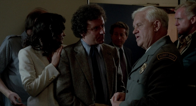 Wide shot frame from The King of Comedy — room, dialogue, uniform